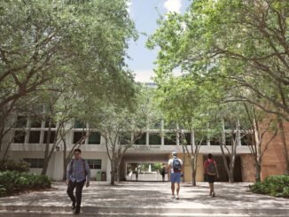 Students walking through a sunlit university campus in Coral Gables, Florida.