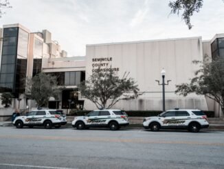 Sheriff vehicles parked in front of Seminole County Courthouse during the day.