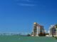 Stunning waterfront view of Sarasota's skyline and bridge under a clear blue sky.