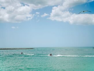 Experience a thrilling jetski ride under a bright sky on the vibrant blue waters of Clearwater Beach, Florida.