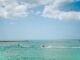 Experience a thrilling jetski ride under a bright sky on the vibrant blue waters of Clearwater Beach, Florida.